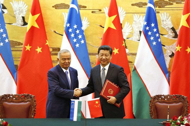 Uzbekistan President Islam Karimov (L) and Chinese President Xi Jinping shake hands during a signing ceremony at the Great Hall of the People (GHOP) in Beijing on August 19, 2014.